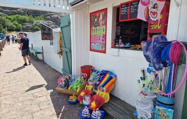The kiosk on a July day, hatch open, with nets, buckets and beach toys outside