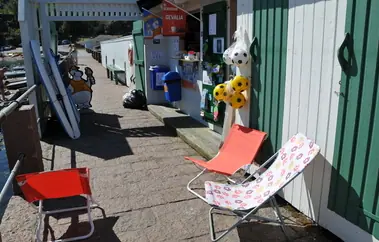 The path along the kiosk with deckchairs and toys set out